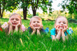 © davit85 - A group of children lying on the green grass in the Park. The interaction of the children.