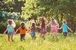 © davit85 - Large group of kids, friends boys and girls running in the park on sunny summer day in casual clothes .
