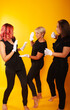 © Marina Chernivetskay - women in white gloves in the image of mimes actress play acting on a yellow background