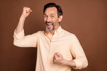 Poster - Photo of age brunet man hands fists yell wear peach shirt isolated on brown color background