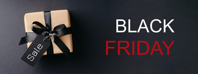 Black Friday banner with gift box on black background.