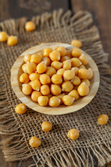 Wall Mural - chickpeas on brown wooden surface