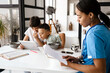 © Drobot Dean - Woman doctor working with papers while her sons using tablet computer