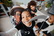© Seventyfour - POV shot of smiling African-American kids wearing Halloween costumes while taking selfie at home, copy space