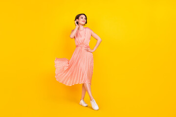 Poster - Full length body size view of lovely cheerful girl posing walking skirt flying isolated over bright yellow color background