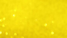 Festive Yellow Glitter Background With Moving And Flicker Particles. Magic Dust, Shiny Texture And Holiday Lights, Flying Particles With Beautiful Bokeh. Shining Christmas Backdrop