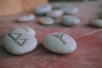 Close up of rune stones. Magic stones with runes on it. Witchcraft aesthetic tools.