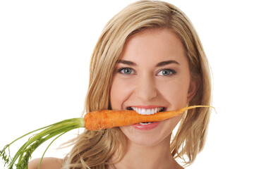 Sticker - Vertical shot of a Polish woman biting a carrot isolated on white background