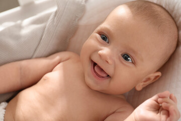 Sticker - Cute little baby lying in soft crib