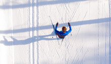 Skier Cross-country Skiing In Snow Forest. Winter Competition, Aerial Top View