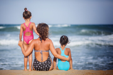 mom with two children enjoying vacation, beach resort, summer vacation