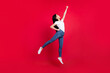 Full body photo of young korean girl power strong jump fly superwoman safety isolated over red color background