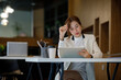 © David - Shot of an Asian young business Female working on laptop computer in her workstation.Portrait of Business people employee freelance online marketing e-commerce telemarketing concept.