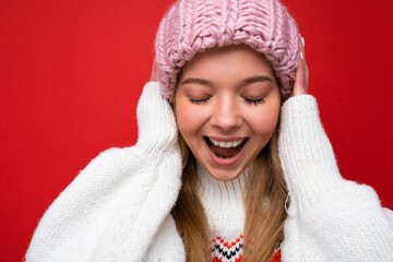 Closeup photo of beautiful positive happy joyful young blonde woman standing isolated over colourful background wall wearing everyday trendy clothes showing facial emotions