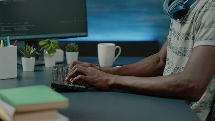 Close up of black hands coding server interface with binary codes on computer. African american coder programming website firewall for protection and software development. Web programmer