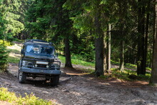 Old Retro Vintage 4x4 SUV On A Dirt Gravel Dirt Road In Summer. Off-road Car Mountain Safari Adventure Nature Trip Travel Concept