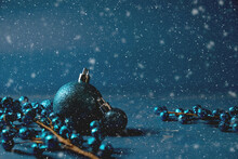 Blue Monochrome Christmas Holiday Background With Glitter Ornament And Snow.