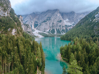 Beautiful landscape of Braies Lake Lago di Braies, romantic place with wooden bridge and boats on the alpine lake, Alps Mountains, Dolomites, Italy, Europe