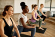 © Drazen - Group of female athletes warm up while doing stretching exercises in health club.