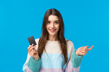 Girl counting pros of new banking system, folding fingers. Attractive female shopaholic ready waste all money on credit card during special winter discounts season, shopping, smiling camera