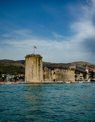 Poster - Scenic vertical shot of the Kamerlengo Tower ruins in Trogir, Croatia, shot from the sea