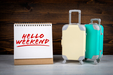 Wall Mural - Hello Weekend. Two suitcases on a wooden table