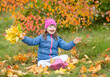 © Ermolaev Alexandr - Happy young girl with down syndrome lying on autumn leaves