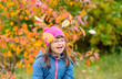 © Ermolaev Alexandr - Happy girl with down syndrome throwing autumn leaves