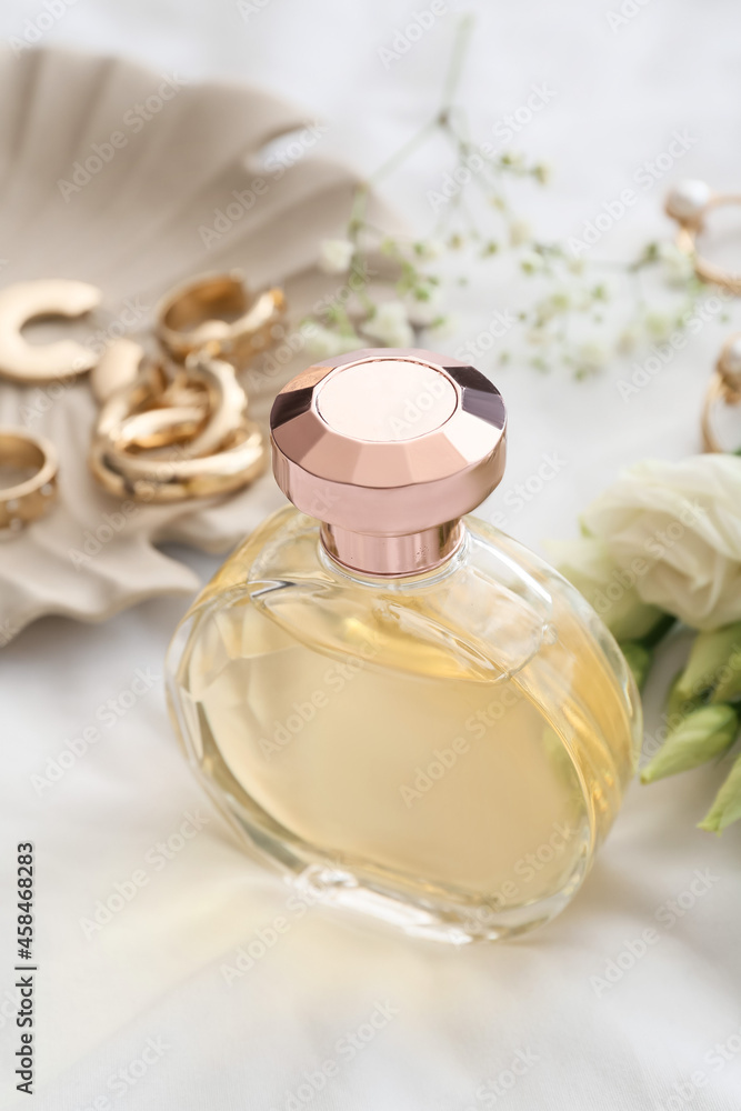 Bottle of perfume on white background, closeup