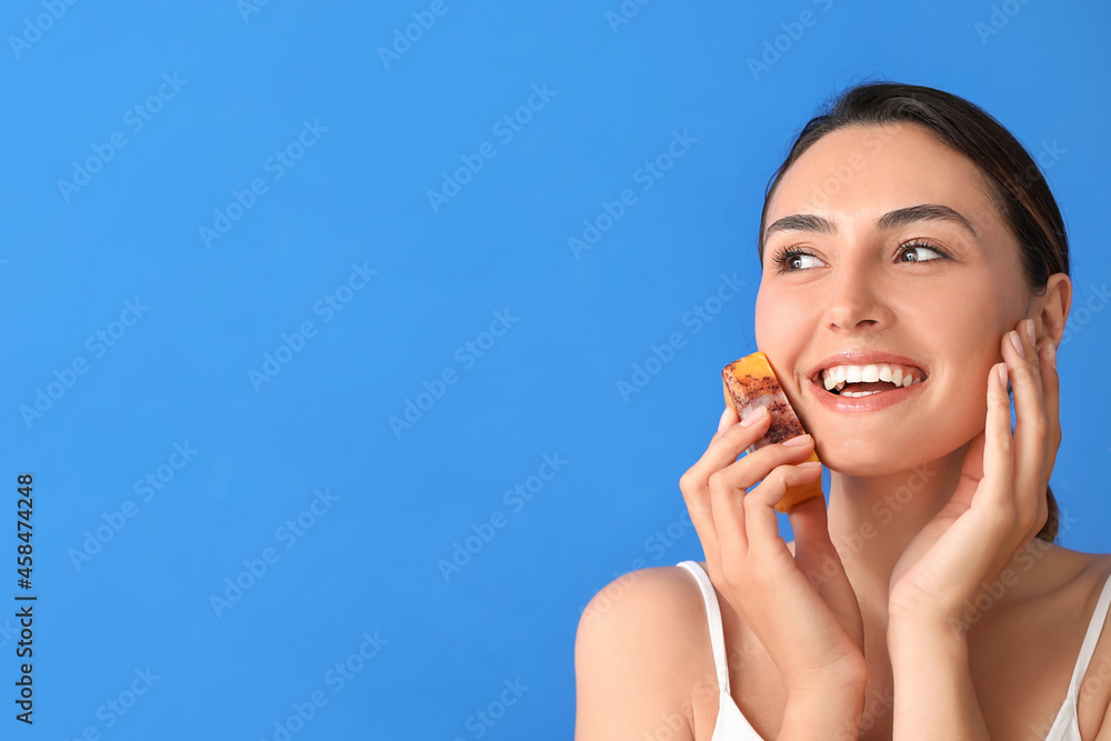 Beautiful young woman with soap on color background