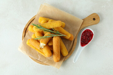 Concept of tasty food with cheese sticks on white textured background