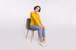 Full size profile side photo of young girl happy positive smile sit stool wear casual outfit isolated over grey color background