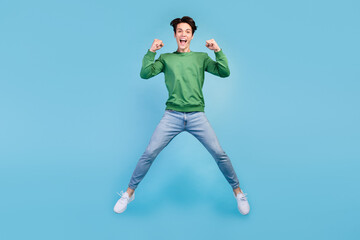 Poster - Full length body size photo guy smiling jumping up careless gesturing like winner isolated pastel blue color background