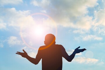 Young man rising on blue sky white clouds abstract background. Freedom feel good