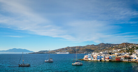 Wall Mural - Sunset in Mykonos, Greece, with cruise ship and yachts in the harbor