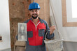 © FotoAndalucia - bricklayer with trowel and cement basket looking at camera