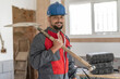 © FotoAndalucia - construction worker with shovel looks at camera with helmet smiling