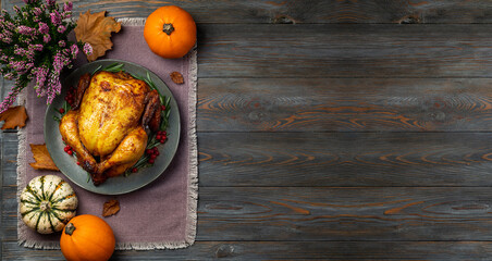 Wall Mural - Thanksgiving Greetings. Roasted chicken or turkey for festive dinner on wooden table. Thanksgiving Day concept. Copy space