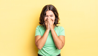 Wall Mural - young pretty girl looking happy, cheerful, lucky and surprised covering mouth with both hands