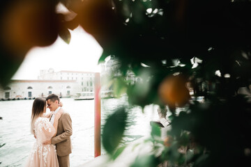 Wall Mural - Gorgeous happy couple standing close to each other and looking in eyes in Venice, Italy