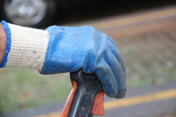 Close-up on the hands of a man with protective gloves.