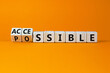 Possible and accessible symbol. Turned wooden cubes and changed the word possible to accessible. Business and possible or accessible concept. Beautiful orange background, copy space.