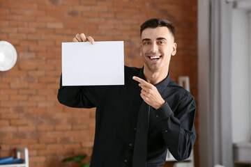 Wall Mural - Young man with blank paper sheet in office