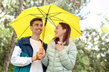 Canvas Print - Young couple with umbrella in park