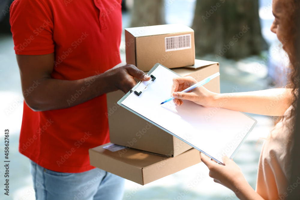 Customer receiving parcel from delivery man