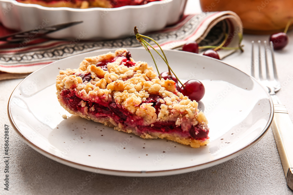 Plate with piece of tasty cherry pie on light background, closeup
