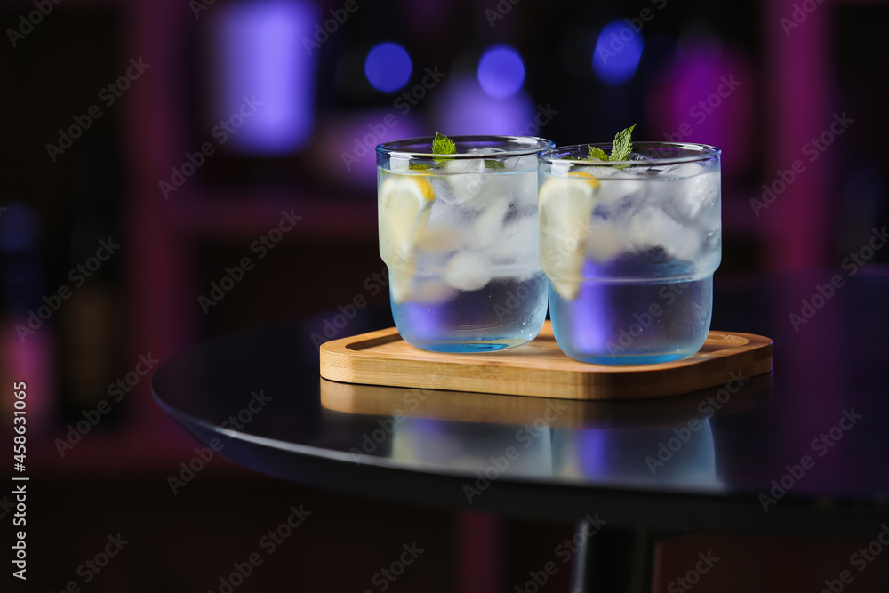 Glasses of cold gin tonic on table in bar