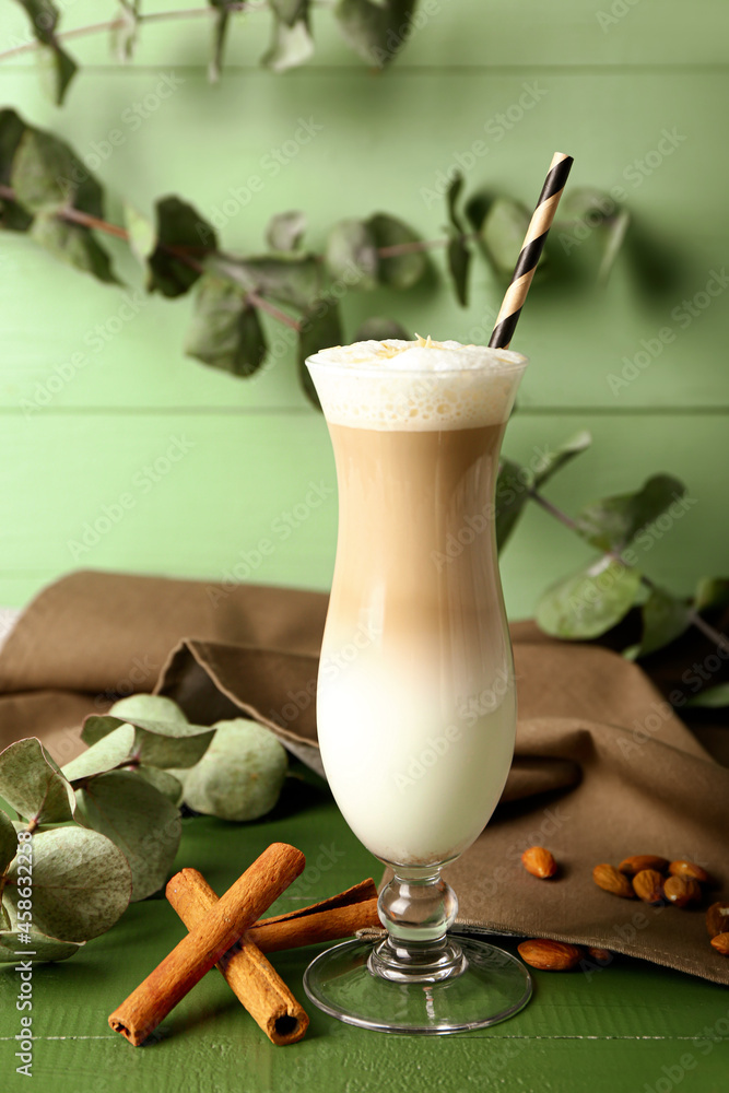 Glass of tasty almond latte on table