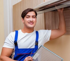 Young man working with kitchen equipment