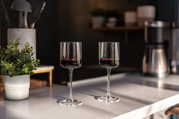 Closeup of two wineglasses on the counter in a modern stylish home